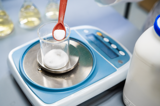 Researcher uses a laboratory balance to weigh a sample