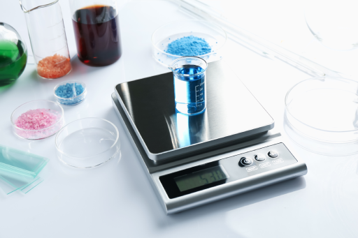 Laboratory balance with beaker and laboratory accessories